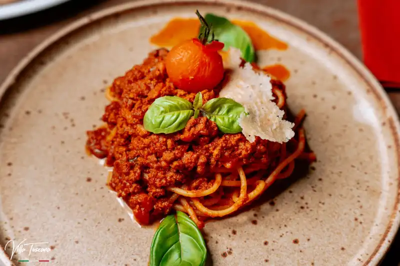Spaghetti with rich Bolognese sauce, shaved cheese and basil